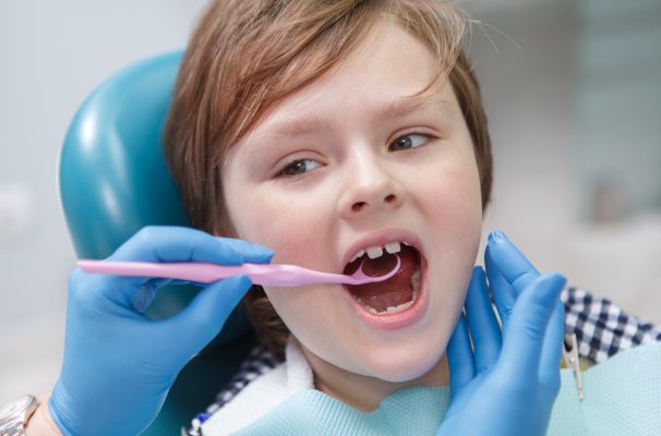Close up of a lovely young boy getting dental examination